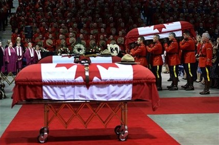 Pallbearers carry the casket of RCMP officer Const. Fabrice Georges Gevaudan, 45, from Boulogne-Billancourt, France, into a regimental funeral for three slain officers in Moncton, N.B., Tuesday, June 10, 2014.