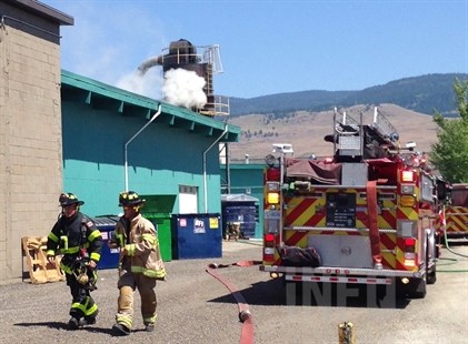 A small plume of smoke can be seen coming from an industrial hopper at a commercial building on Pinto Road, July 9, 2014.