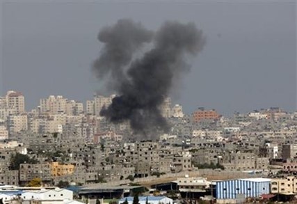 Smoke rises following an Israeli strike on Gaza, seen from the Israel-Gaza border, Saturday, July 12, 2014.