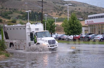A truck navigates a flash flood area during a storm in Vernon, July 23, 2014.