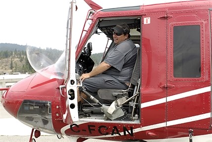 Wildcat Helicopters pilot Robert Stevens and the Bell 212 he used to fight the Smith Creek fire.