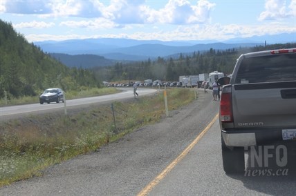 Motorist, many in RV's take a moment to stretch their legs with traffic at a standstill following an accident on Highway 97C near the Loon Lake Road exit, Friday, July 25, 2014.
