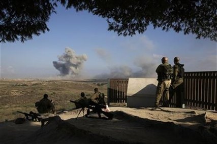 Israeli soldiers observe bombings of Gaza before a 12-hour cease-fire, seen from the border of Israel and the Gaza Strip, Saturday, July 26, 2014.