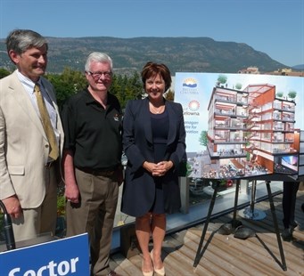 B.C. Minister of Technology Andrew Wilkinson, left to right, Kelowna Mayor Walter Grey and B.C. Premier Christy Clark with an artist's rendering of the Okanagan Centre for Innovation, Monday, July 28, 2014.