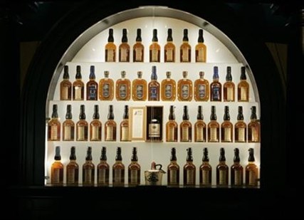 In this Wednesday, April 8, 2009, file photo, bottles of bourbon are on display in a case at the Heaven Hill Bourbon Heritage Center in Bardstown, Ky.