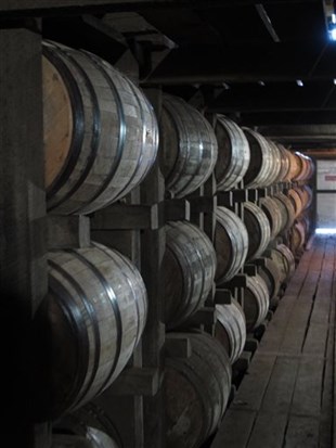 In a July 24, 2014 photo, bourbon supplies age in barrels at the Jim Beam distillery in Clermont, Ky.
