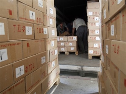 Workers unloading aid delivered from Russia in the town of Luhansk, eastern Ukraine, Saturday, Sept. 13, 2014.