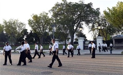 Uniformed Secret Service officers walk along Pennsylvania Avenue in front of the White House, Saturday, Sept. 20, 2014.