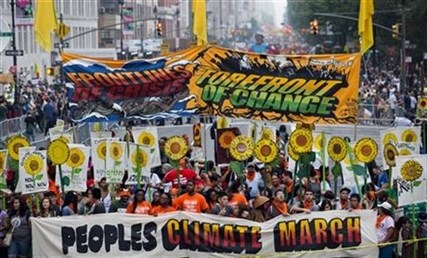 People gather before the People's Climate March in New York Sunday, Sept. 21, 2014.
