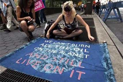 Demonstrators prepare a sign before the People's Climate March Sunday, Sept. 21, 2014 in New York.