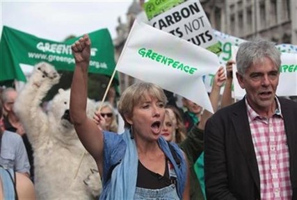 British actress Emma Thompson, centre and John Sauven from Greenpeace join an estimated 40,000 thousand people marching in London, Sunday, Sept. 21, 2014 as part of the People's Climate March.