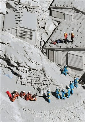 Firefighters and members of the Japan Self-Defense Forces prepare to rescue climbers near the peak of Mount Ontake in central Japan, Sunday, Sept. 28, 2014.