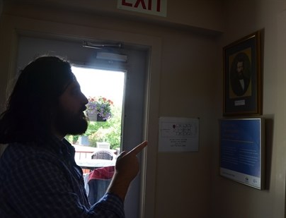 Walraven points to a photo of Frederic Ozanam the founder of the Society of St. Vincent De Paul that runs Ozanam House. The society procures funding and donations for the house, with the remaining funds provided through the resident's income assistance.