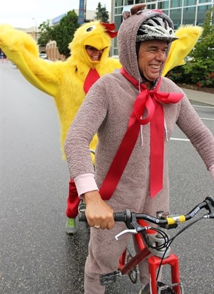 Penticton acting mayor Garry Litke and city manager Annette Antoniak dressed up as a chicken and deer to ride in front of city hall on Wednesday.