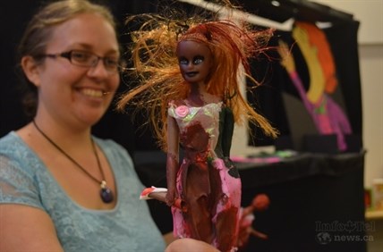 Stephanie Vollick holds a zombified Barbie, inspired by the hit T.V. show The Walking Dead and science fiction novels. 