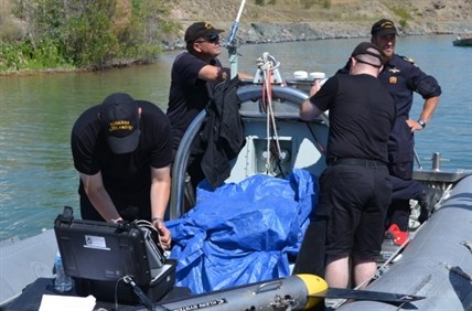 Divers from the Pacific Fleet Diving Unit preparing to head out for another sweep of Kalamalka lake. 