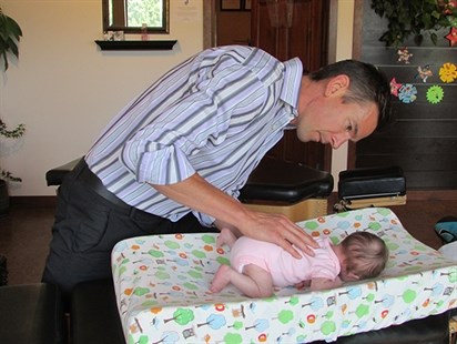 Dr. Whillans provides care for a two week old little girl in his Kelowna clinic. 