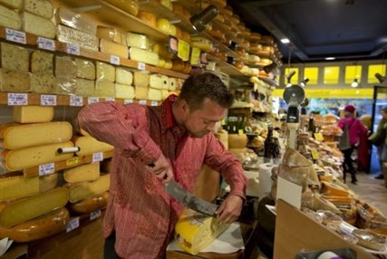 Maarten Huiskamp cuts a piece of Dutch cheese in De Kaaskamer store in Amsterdam last week. 