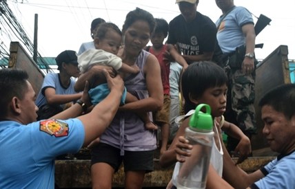 Residents living near the slopes of Mayon volcano are evacuated to public schools by police in anticipation of the powerful Typhoon Haiyan that threatened Albay province and several provinces in central Philippines.
