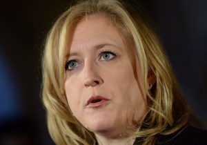 Transport Minister Lisa Raitt makes an announcement on Parliament Hill in Ottawa on Wednesday, Nov. 20, 2013. Raitt is defending Canada Post's decision to phase out urban mail delivery over the next five years while hiking the price of stamps.