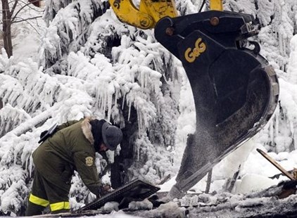 Emergency workers continue the search for victims Saturday, January 25, 2014 in L'Isle-Verte, Que. at the scene of a fatal fire at a seniors residnce Thursday, Jan, 22, 2014.