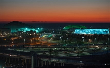 The Bolshoi Ice Dome, background center, Iceberg skating arena, right, and the Fisht Olympic Stadium, left, are illuminated at night in Sochi, Russia.