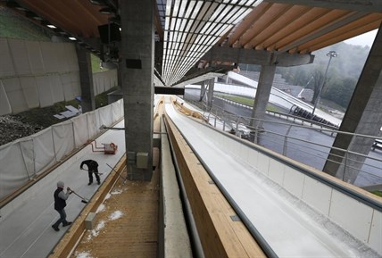 Workers are busy operating in the Sanki Sliding Center in Krasnaya Polyana outside the Black Sea resort of Sochi, Russia.