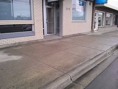 The sidewalk in the 100 block of Highway 33 where Christopher Ausman's, 32, body was found on Saturday, Jan. 25, 2014 has been power washed to removed the blood.