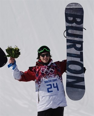 Canada's Mark McMorris celebrates on the podium after winning the bronze medal in the men's snowboard slopestyle final at the Rosa Khutor Extreme Park, at the 2014 Winter Olympics in Krasnaya Polyana, Russia, Saturday, Feb. 8, 2014.