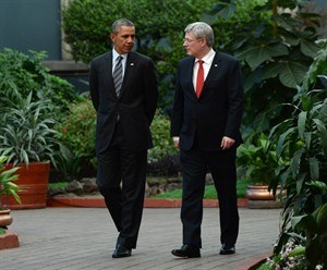 Prime Minister Stephen Harper walks with U.S. President Barack Obama during the North American Leaders Summit in Toluca, Mexico on Wednesday, Feb.19, 2014. Harper and Obama have a couple of cases of beer riding on the outcome of the men's and women's games in Olympic hockey.