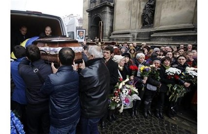 People carry the coffin in Lviv, western Ukraine, Saturday, Feb. 22, 2014.
