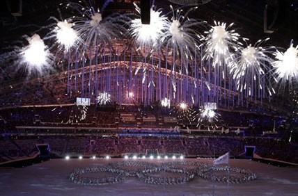 Fireworks light up the arena as artists make a formation in the shape of the Olympic Rings during the closing ceremony of the 2014 Winter Olympics, Sunday, Feb. 23, 2014, in Sochi, Russia.
