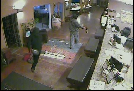 Second suspect enters lobby with trolly.