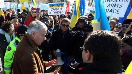 Phillipe Zeller, left, France's Ambassador to Canada, meets with members of the Canadian Ukrainian community demonstrating outside the French embassy in Ottawa Sunday March 9, 2014.