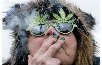 The Peace Tower is reflected in the sunglasses of a woman smoking a joint at the 4/20 rally on Parliament Hill last April 20.