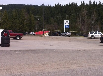The RCMP Emergency Response Team members can be seen to the left of the Esso sign unloading equipment.
