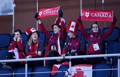 Team Canada women cheer on the mens team in Sochi, Russia earlier this week.