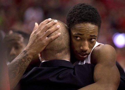 Toronto Raptors guard DeMar DeRozan, right, gets a hug as he walks off the floor after losing to the Brooklyn Nets in Game 7 of the opening-round NBA basketball playoff series in Toronto, Sunday, May 4, 2014.