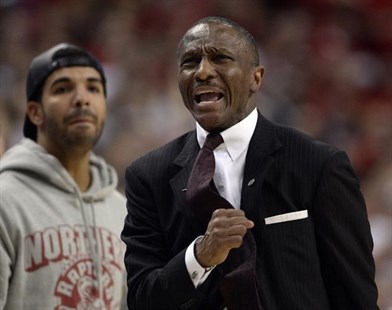 Toronto Raptors head coach Dwane Casey, right, and rapper Drake react near the end of a loss to the Brooklyn Nets in Game 7 of the opening-round NBA basketball playoff series in Toronto, Sunday, May 4, 2014.
