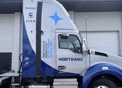 Natural gas powered transport truck hauling lumber through Okanagan