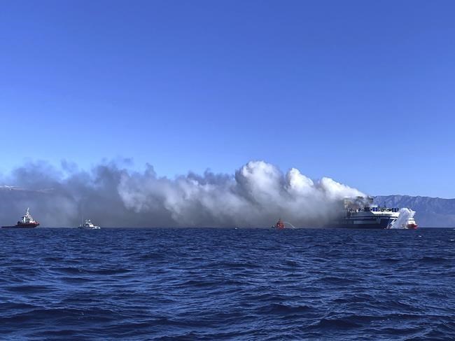 Greek rescuers search burning ferry for 12 missing people