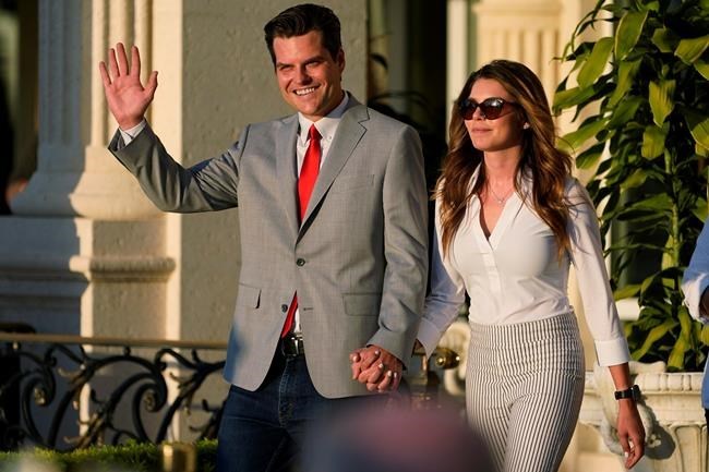 FILE - In this April 9, 2021, file photo Rep. Matt Gaetz, R-Fla., and his girlfriend Ginger Luckey enter 'A Woman for American First' event in Doral, Fla. Before Gaetz rose to national prominence as an ardent backer of Donald Trump, he carved out an unusual reputation in Florida: a Republican lawmaker who wanted to liberalize marijuana laws. (AP Photo/Marta Lavandier, File)