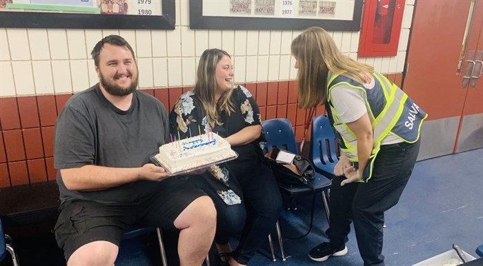 The Westside Salvation Army’s Captain Jennifer Henson is seen surprising a young couple with cake. This young couple was celebrating their two-year wedding anniversary when they were evacuated from their home.  
