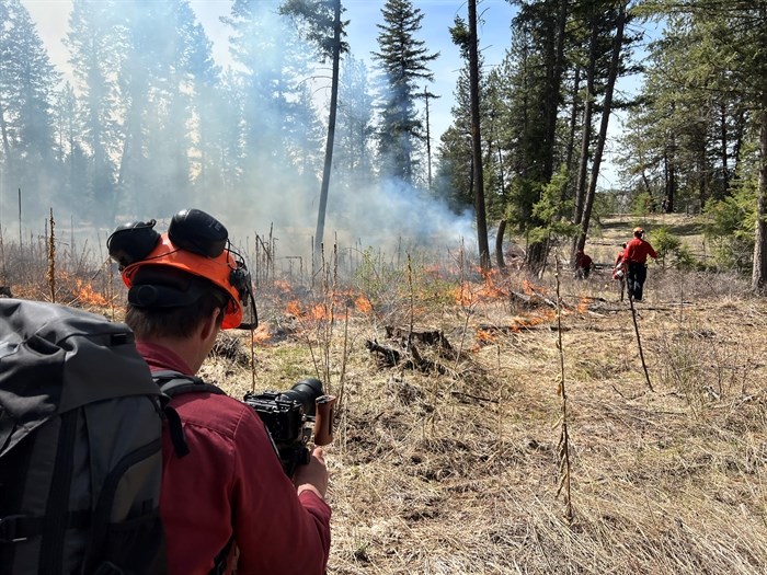Videographer Billy Stevens shooting a video of a prescribed burn near Rock Creek.
