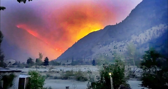 Flames from the Crater Creek wildfire light up the night sky in Cathedral Park.
