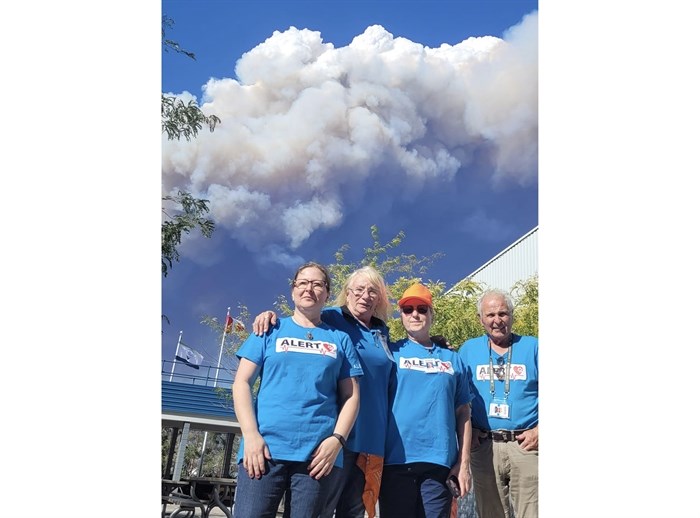 Animal Lifeline Emergency Response Team members (left to right) Naomi Z., Lynn D., Moneca F. and Ed M. with the backdrop of the McDougall Creek fire in West Kelowna.