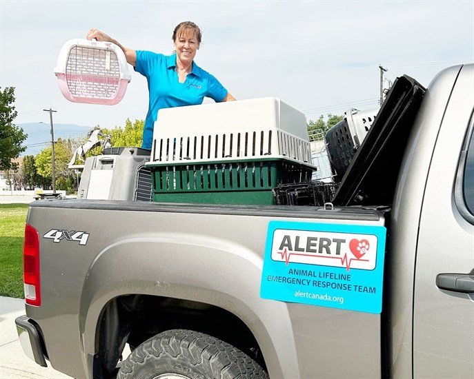 Cheryl E. of Animal Lifeline Emergency Response Team with some of the many carriers used by volunteers to help evacuate domestic animals in times of disaster.