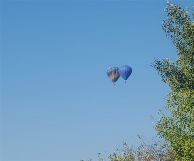Air balloons floating side-by-side, Armstrong. 