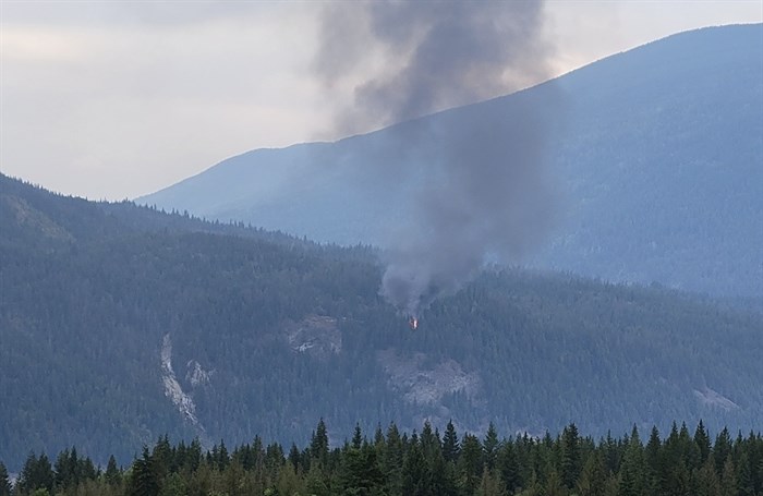 A plume of smoke can be seen from a house fire in the North Shuswap, Monday, Sept. 18, 2023.