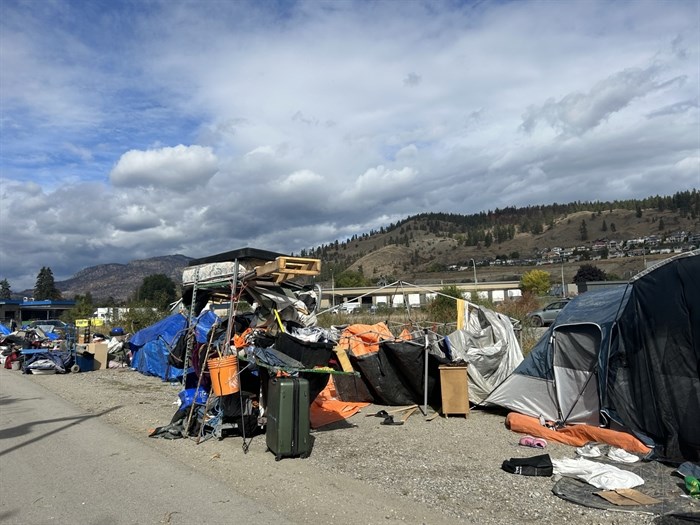 Homeless people living in a city encampment along the Okanagan Rail Trail in Kelowna are trying to fit all their belongings into a small area while crews cleanup the area, Wednesday, Oct. 4, 2023.